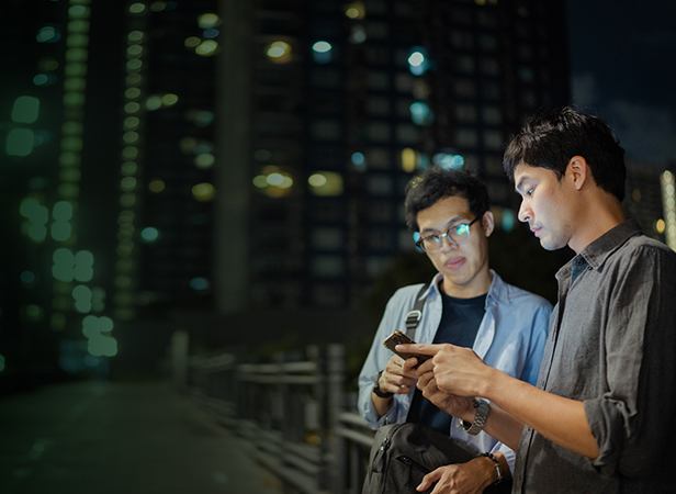 two men looking at phone