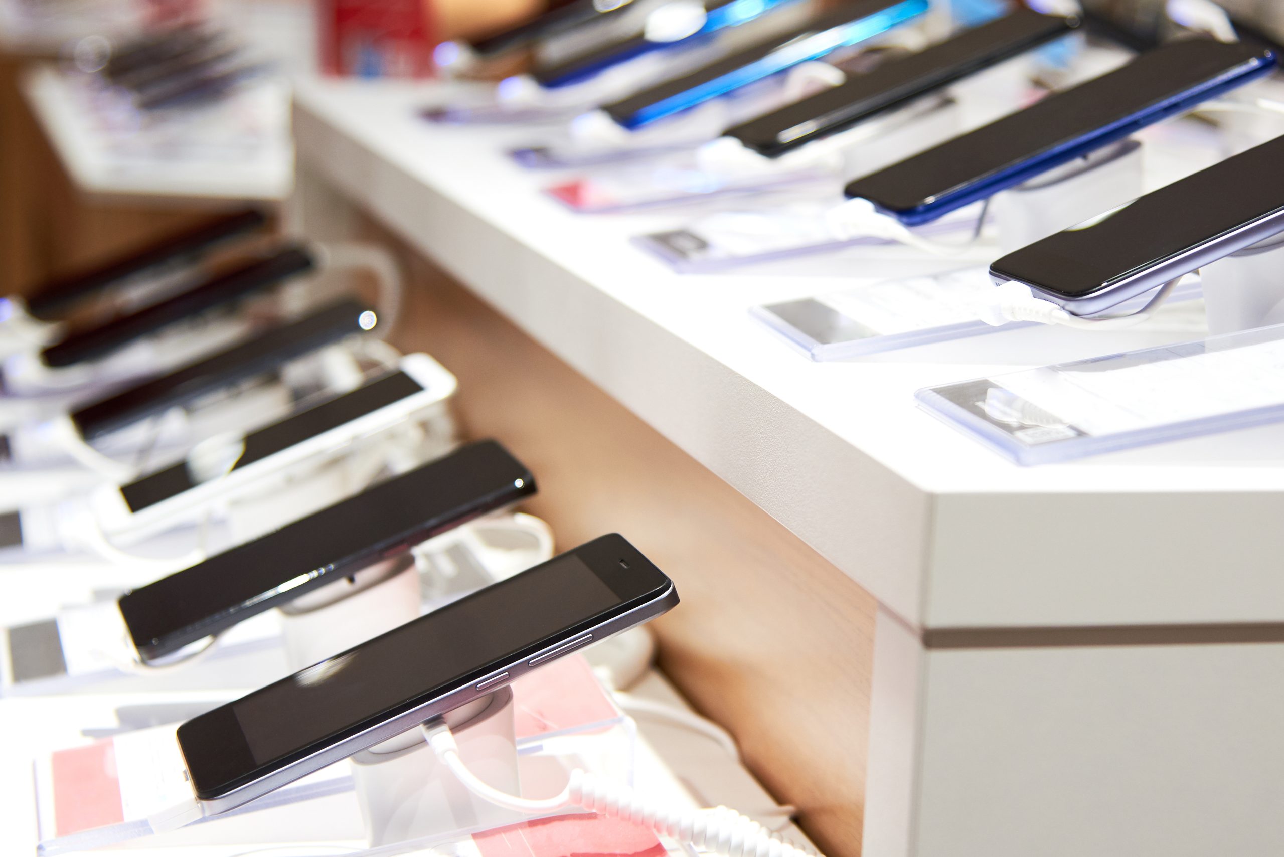 Smartphones on the counter of a modern electronics store