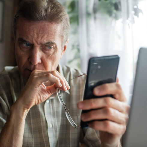 man confused at phone